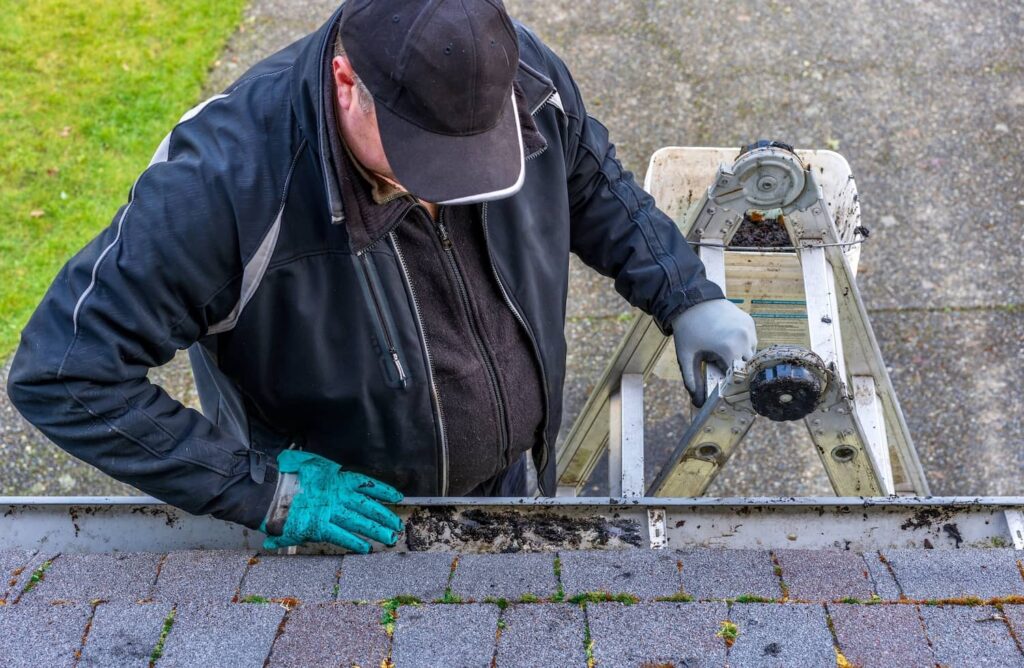 A homeowner assessing their roof's condition to prevent or spot wind damage.