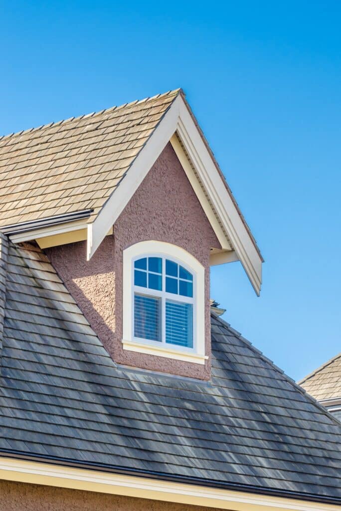 roof shingles and top floor window of alabama home