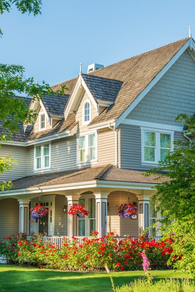 suburban two story home shown with vibrant landscaping